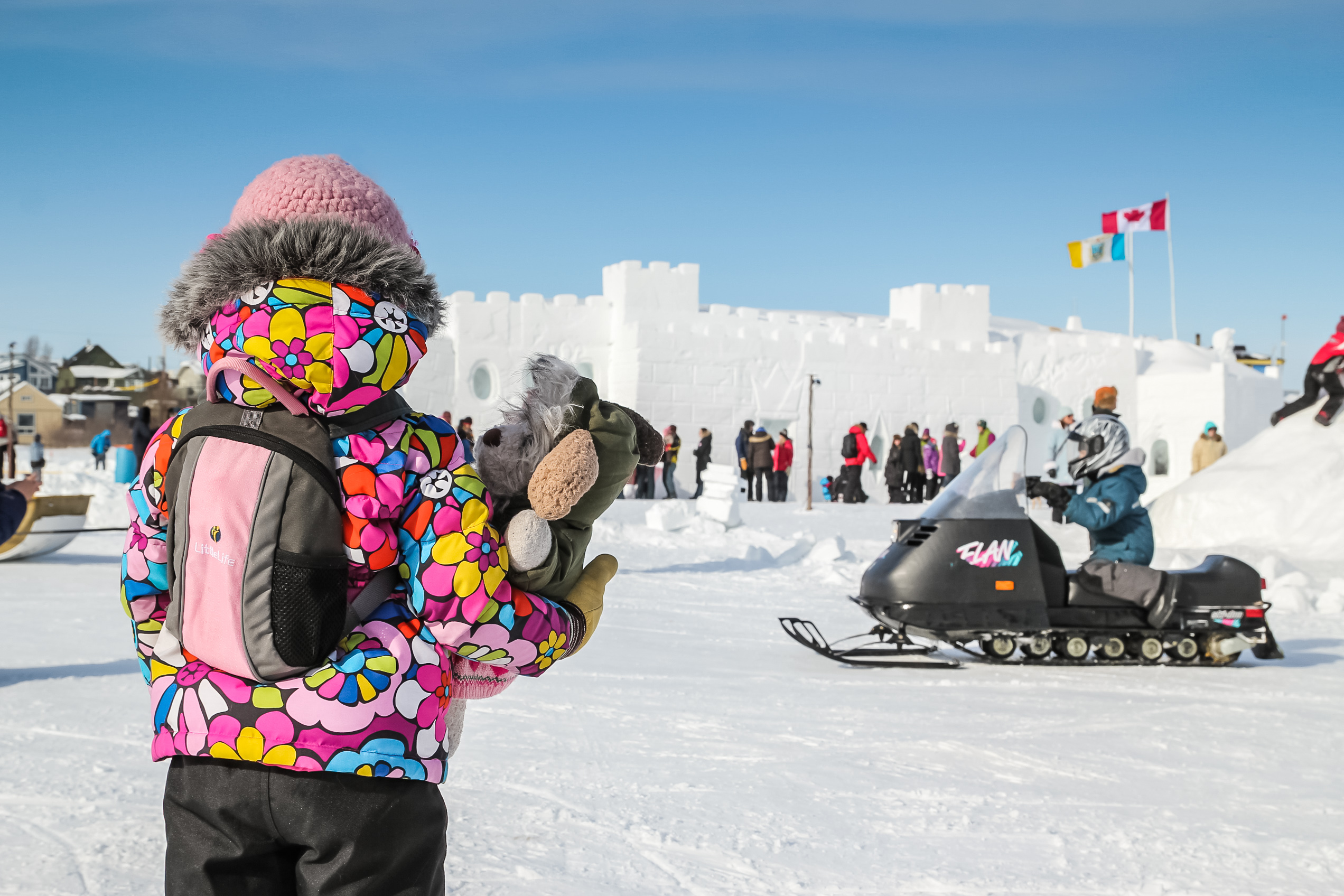 People at the annual Snow king Winter festival, outside of a snow Castle in the NWT