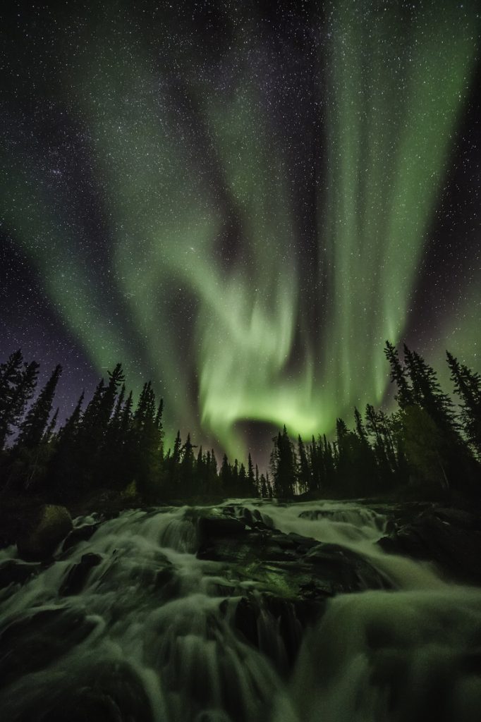 The Northern lights dance above Cameron Falls in the Northwest Territories