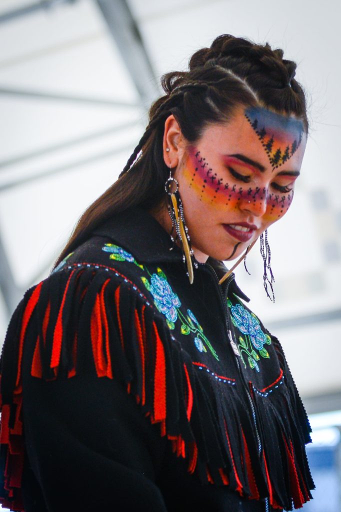 Kyra Macdonald wearing Indigenous clothing and jewelry at the Great Northern Arts Festival. 