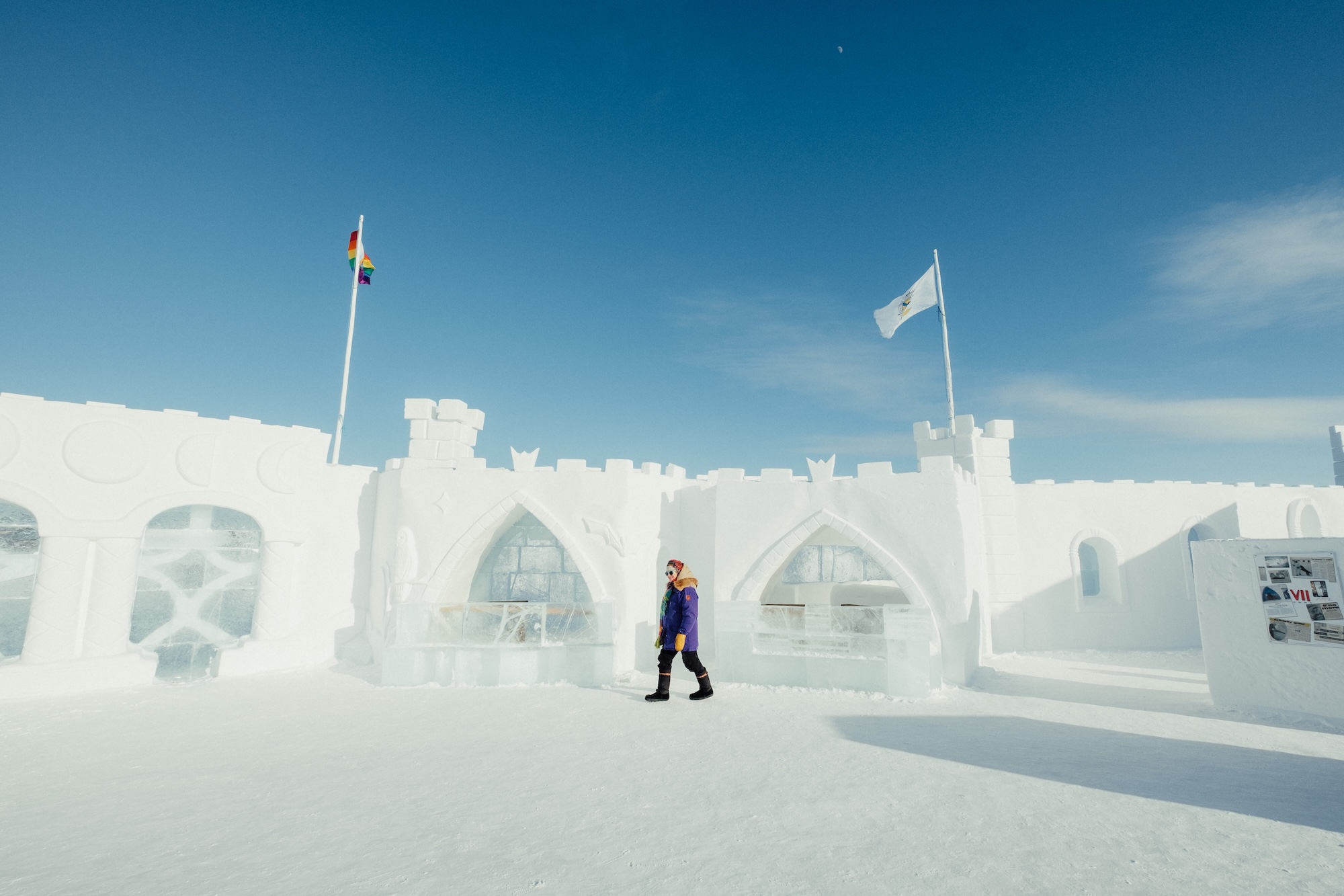 A person walks around the snow castle in Yellowknife NWT. Build every year as part of the Snowcastle winter festival
